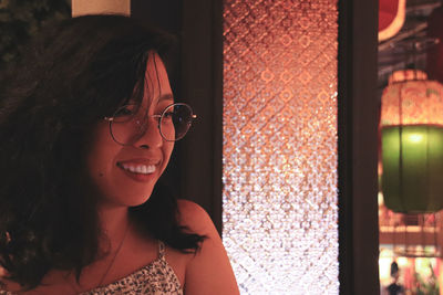 Portrait of smiling young woman looking away