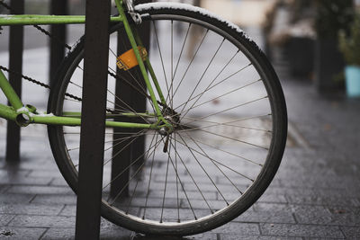 Close-up of bicycle wheel on footpath