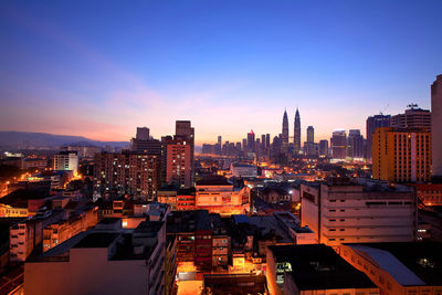View of city lit up against sky