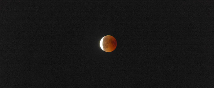 Low angle view of moon against sky at night