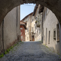 Empty alley amidst buildings in town