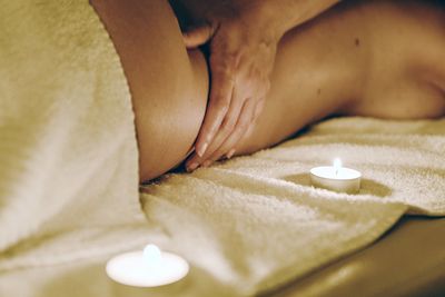 Cropped image of therapist massaging woman at spa