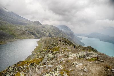 Scenic view of mountains against cloudy sky