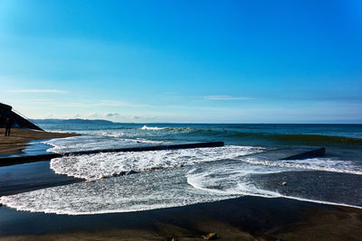 Scenic view of sea against blue sky