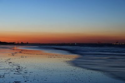 Scenic view of sea against clear sky at sunset
