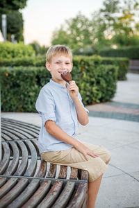 Portrait of smiling boy sitting outdoors