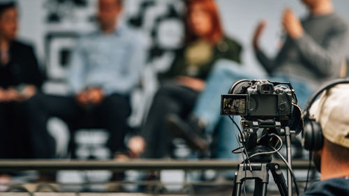 Cameras at a panel discussion conference