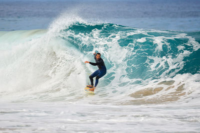 Full length of man surfing in sea