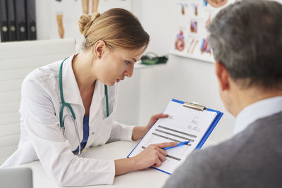 Midsection of woman with text on mobile phone