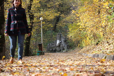 Woman standing amidst plants during autumn