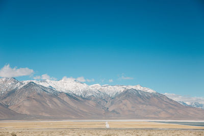 Scenic view of mountain against blue sky