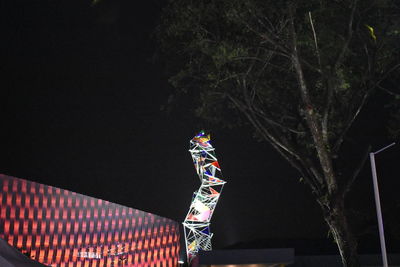 Low angle view of illuminated flag at night