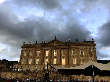 Low angle view of building against cloudy sky