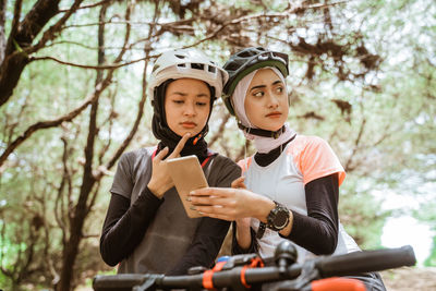 Young females looking at mobile phone at park