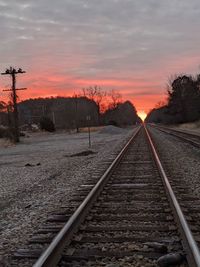 View of railroad tracks against sky during sunset