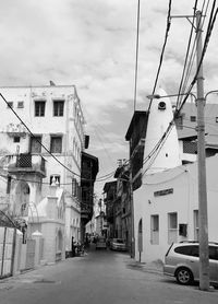 Street amidst buildings in city against sky