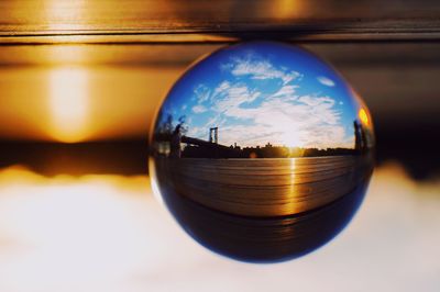 Close-up of glass of water against sky