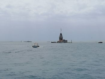 Ship sailing on sea against sky