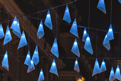 Low angle view of umbrellas hanging against ceiling