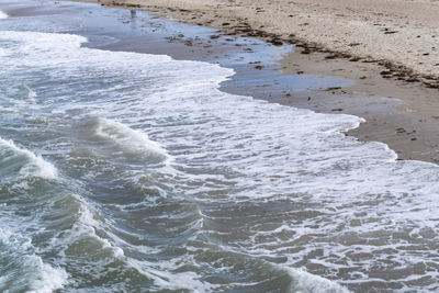 High angle view of waves rushing towards shore