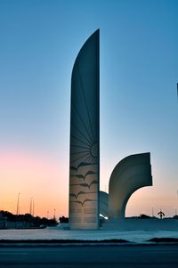 Modern building against sky during sunset