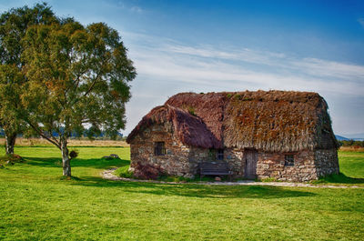 Built structure on field against sky