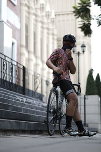 Woman riding bicycle on street in city