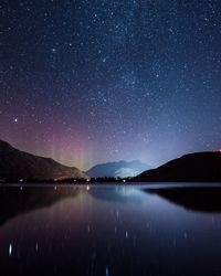 Star trails over lake at night