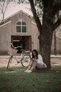 Side view of woman sitting on field