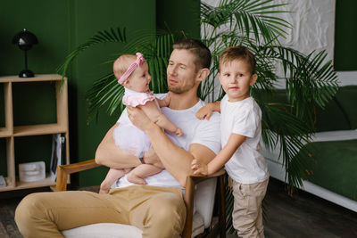 Side view of young woman sitting at home