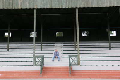 Man sitting on steps of stadium