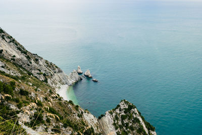 High angle view of rocks by sea