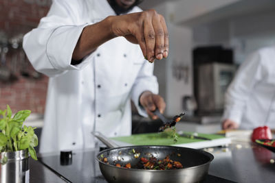 Midsection of man preparing food