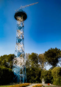 Low angle view of communications tower against sky