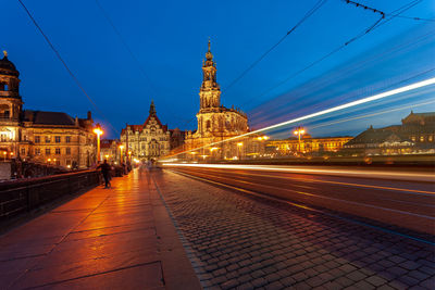 Illuminated city street and buildings at night