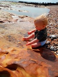High angle view of boy playing at beach