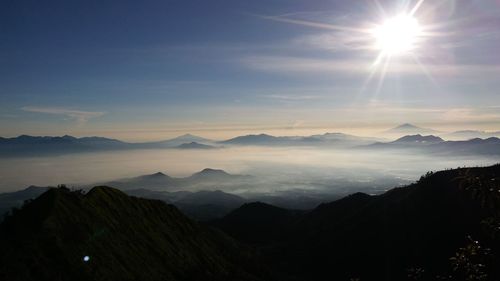 Scenic view of silhouette mountains against sky at sunset