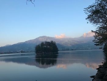 Scenic view of lake and mountains against clear sky