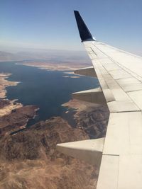 Cropped image of airplane flying over landscape