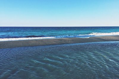 Scenic view of sea against clear blue sky