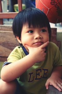 Close-up of thoughtful boy sitting on bench