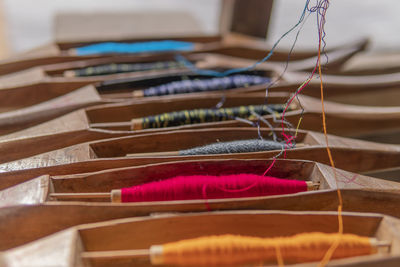 Close-up of multi colored spools in workshop