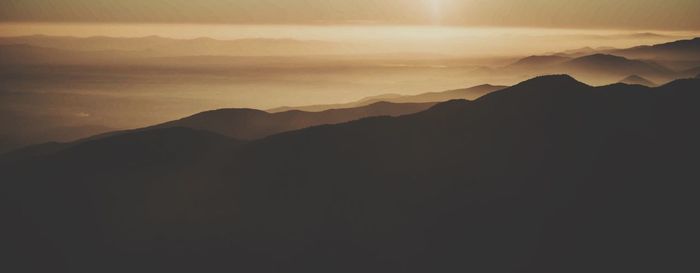 Scenic view of mountains against dramatic sky