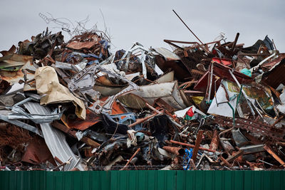 Metal scrap waste dump for recycling. city fenced landfill. iron garbage and trash.