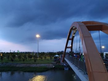 Bridge over river against sky at dusk