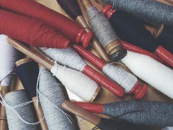 High angle view of thread spools on table