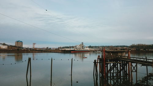 Harbor against cloudy sky
