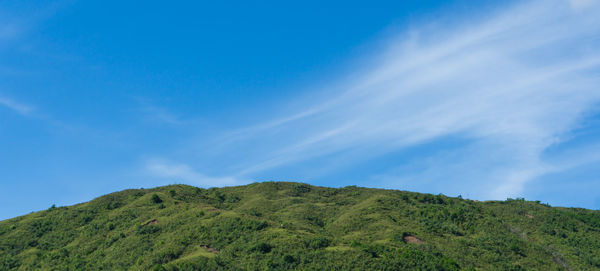 Low angle view of mountain against blue sky