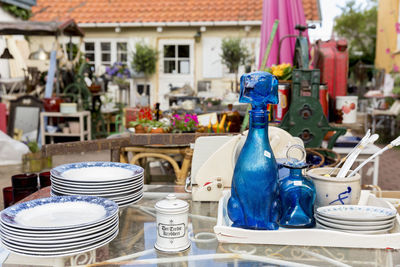 Plates and glass bottles on table