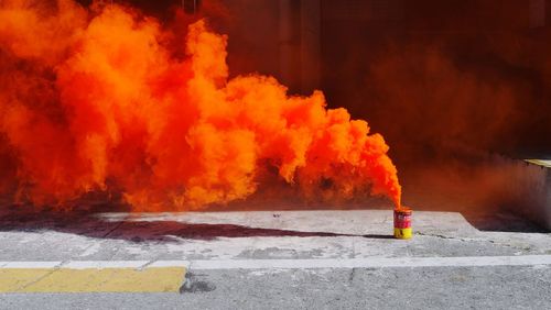 Fire hydrant on street against orange wall